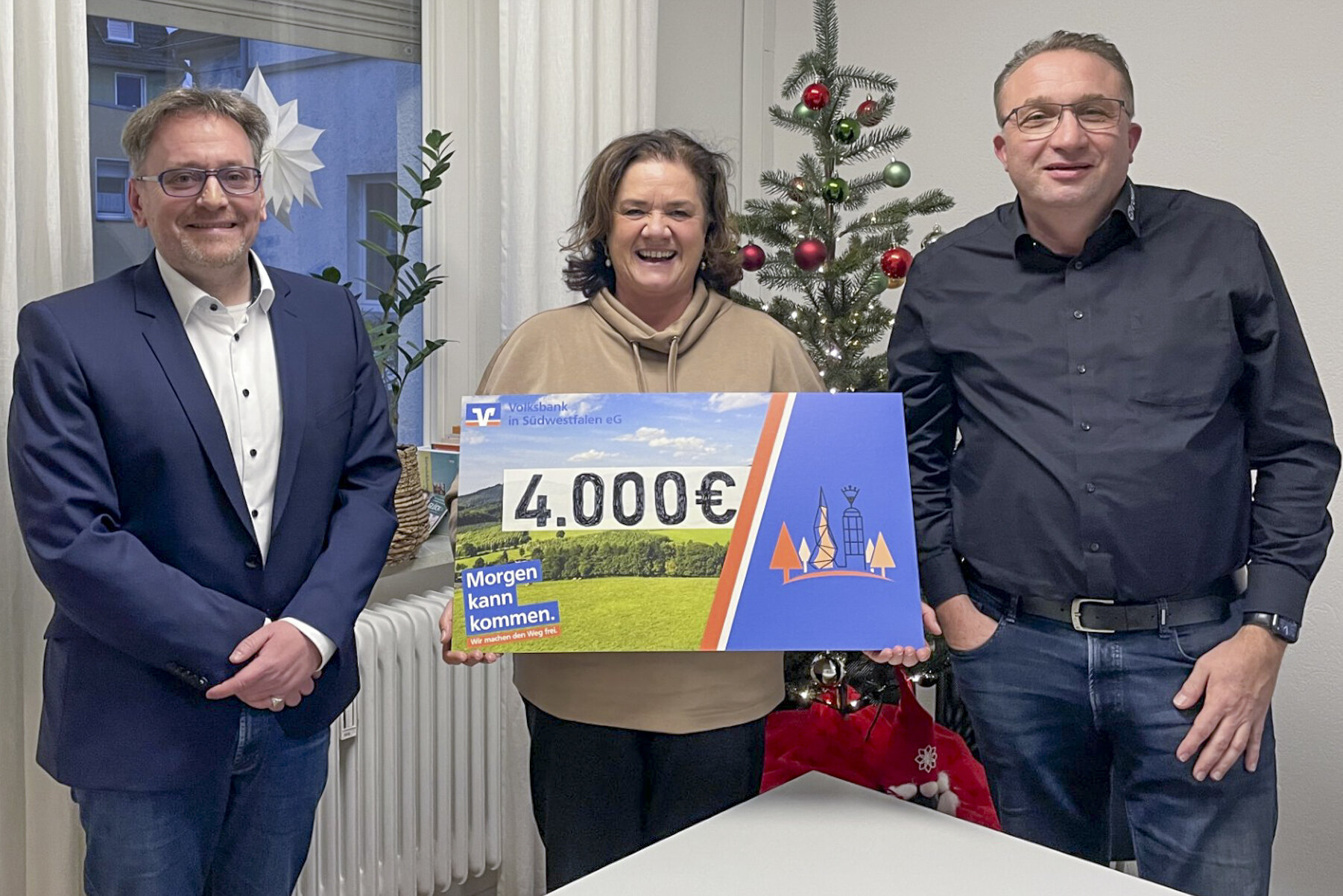 Überreichten den symbolischen Spendenscheck: Wolfgang B. Klein (li.) und Torsten Schmitt zusammen mit Einrichtungsleitung Andrea Krumm-Tzoulas